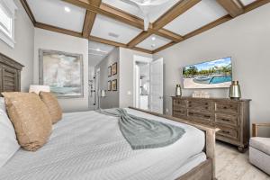 a bedroom with a large bed and a tv at Beach Fanta Sea - 149 in Bailey Hall +72 photos