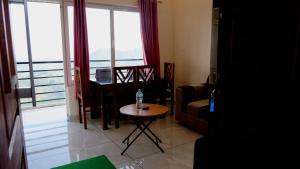 a living room with a table with a water bottle on it at Elora Homes in Vagamon