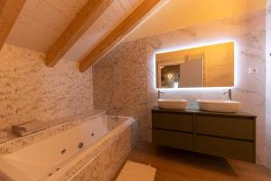 a bathroom with two sinks and a large tub at Alojamientos La Antigua in Molina de Aragón +112 photos