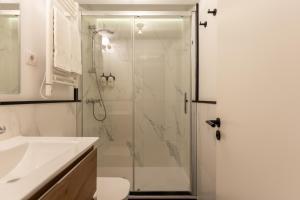 a bathroom with a shower and a toilet and a sink at Colectia Stays Atocha in Madrid +62 photos