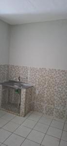 a bathroom with a sink and a tiled wall at Apartamento in Belém +4 photos