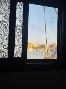 a window with a view of a body of water at Mostafa Jamaica guesthouse in Aswan
