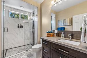 a bathroom with a shower and a toilet and a sink at Minutes 2 NAU & downtown & Snowbowl! in Flagstaff +13 photos