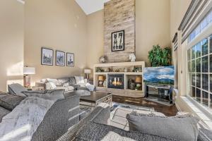 a living room with a couch and a tv at Minutes 2 NAU & downtown & Snowbowl! in Flagstaff