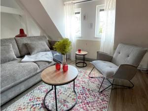 a living room with a couch and two chairs and a table at Thüringer Wald-Zauber in Zella-Mehlis