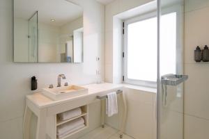 a white bathroom with a sink and a shower at Hotel Palma Avenidas in Palma de Mallorca +16 photos