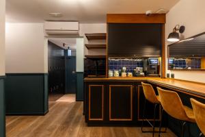 a kitchen with a bar with chairs in it at Colectia Stays Atocha in Madrid