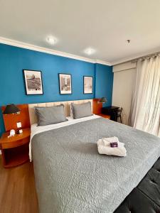 a bedroom with a large bed with a towel on it at Flat barra residence-4 pessoas-Fa1204-3 in Rio de Janeiro