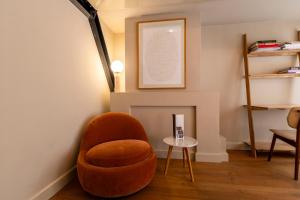 a living room with a chair and a table at Townhouse 't Raap in Amsterdam +35 photos