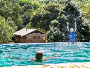two people in the water in a swimming pool at AfriCamps at Mackers in Hazyview