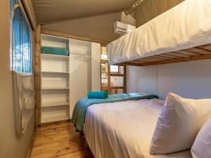 a bedroom with two bunk beds and a window at AfriCamps at Mackers in Hazyview