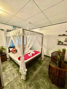 a bedroom with a bed with a canopy at Double W Grand Villa Madiha in Matara