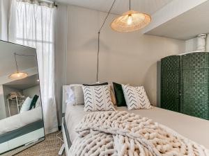 a bedroom with a bed with a large blanket at Boho, Walk East Village, Downtown, Free Parking in Des Moines