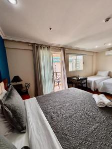 a large bedroom with two beds and a window at Flat barra residence-4 pessoas-Fa1204-3 in Rio de Janeiro