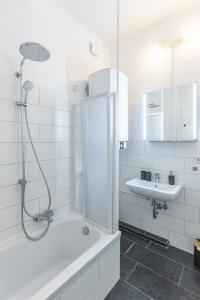 オスナブリュックにあるModernes 72qm Apartment zentral mit Küche und Boxspringbettのシャワーと洗面台を備えた白いバスルーム