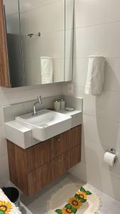 a bathroom with a sink and a mirror at Flat - Beira-Mar - Piscina - Intermares in Cabedelo