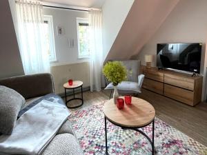 a living room with a couch and a tv at Thüringer Wald-Zauber in Zella-Mehlis
