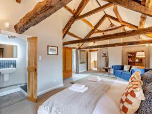 a living room with a blue couch and wooden ceilings at 3 Bed in Appleby 94764 in Brampton