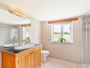 a bathroom with two sinks and a toilet and a window at 3 Bed in Appleby 94764 in Brampton +19 photos