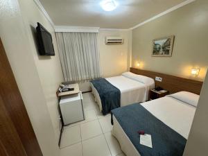 Ένα ή περισσότερα κρεβάτια σε δωμάτιο στο Cedro Hotel