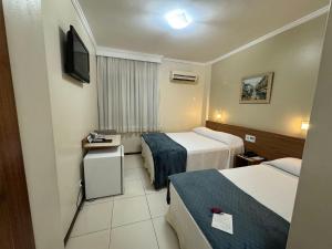 Ένα ή περισσότερα κρεβάτια σε δωμάτιο στο Cedro Hotel