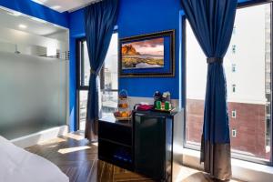 a bedroom with blue walls and blue drapes at Heritage hotel in Nha Trang +11 photos
