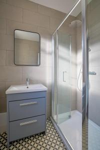 a bathroom with a sink and a shower at The White City Apartment in Oban +39 photos