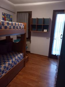 a bedroom with a bunk bed and a window at Locazione turistica Gisella 