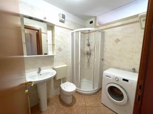a bathroom with a shower toilet and a sink at Alessia in Grado