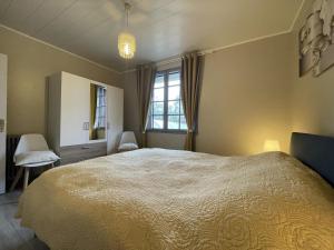 a bedroom with a large bed and a window at Jardin fleuri in Sus