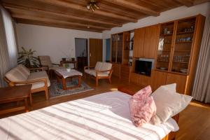 a bedroom with a bed and a living room at Ferienhaus Kaiser Lothar in Reutte