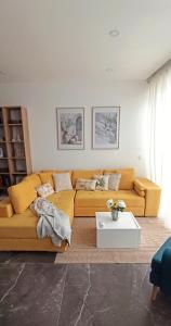 a living room with a couch and a table at Cozy penthouse with Citadel view near to Victoria in Sannat