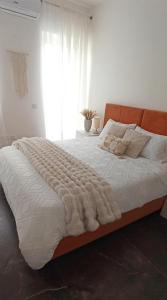 a bedroom with a large bed with a blanket on it at Cozy penthouse with Citadel view near to Victoria in Sannat