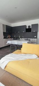 a kitchen with a yellow bed in a room at Cozy penthouse with Citadel view near to Victoria in Sannat