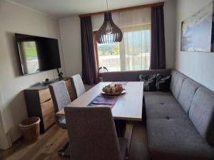 a living room with a table and a couch at Ferienhaus DaPfusterer in Bad Mitterndorf