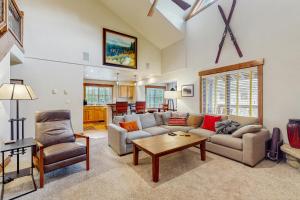a living room with a couch and a table at Pines at Orehouse 301 PH2 in Steamboat Springs