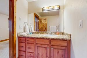 a bathroom with a sink and a mirror at Pines at Orehouse 301 PH2 in Steamboat Springs +24 photos