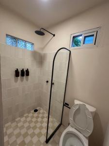 a bathroom with a shower and a toilet at PointBreak Surfhouse in Puerto Escondido