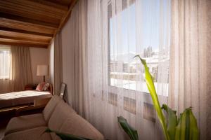 a living room with a couch and a window at Ferienhaus Kaiser Lothar in Reutte