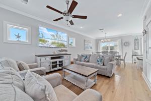 a living room with a couch and a table at Waves & Wildlife Getaway at Summer Salt in Orange Beach