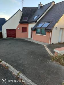 a house with a garage and a driveway at Ti harmoniel in Guingamp