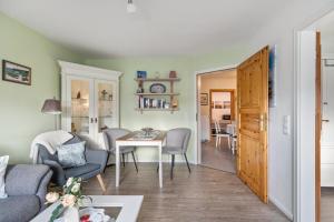 a living room with a couch and a table at Ferienhaus Smilla in Meldorf