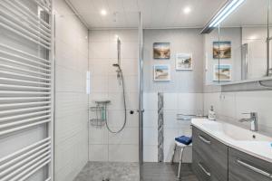 a bathroom with a shower and a sink at Ferienhaus Smilla in Meldorf +20 photos