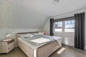 a bedroom with a bed and a large window at Ferienhaus Smilla in Meldorf