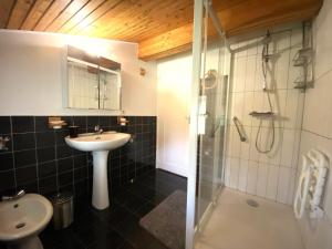 a bathroom with a sink and a shower at Amaika karkula in Sare