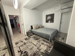 a bedroom with a bed and a rug at Premium Apartment in Craiova