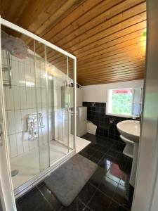 a bathroom with a glass shower and a sink at Amaika karkula in Sare