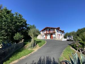 a house with a car parked on the side of a road at Amaika karkula in Sare