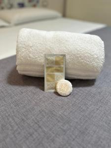 a pile of towels and a condom on a bed at Casa Roberta in Taranto