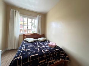Postel nebo postele na pokoji v ubytování Apartamento Solar do Centro - Gramado RS